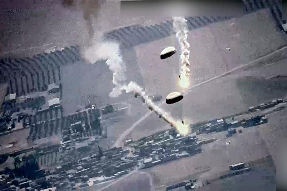 In this image from a video released by the U.S. Air Force, parachute flares, that according to the U.S. Air Force, released by a Russian SU-35 are visible near a U.S. Air Force MQ-9 Reaper drone over Syria on July 5, 2023. (U.S. Air Force via AP)