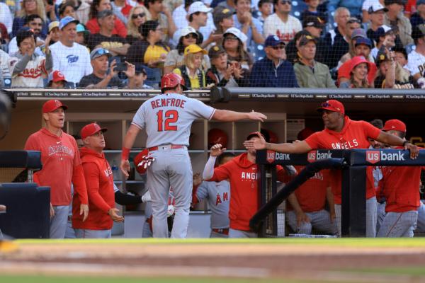 Hunter Renfroe (12) is congratulated at the dugout after scoring on a single by Luis Rengifo (2) of the Los Angeles Angels during the second inning of a game against the San Diego Padres at PETCO Park in San Diego on July 5, 2023. (Sean M. Haffey/Getty Images)