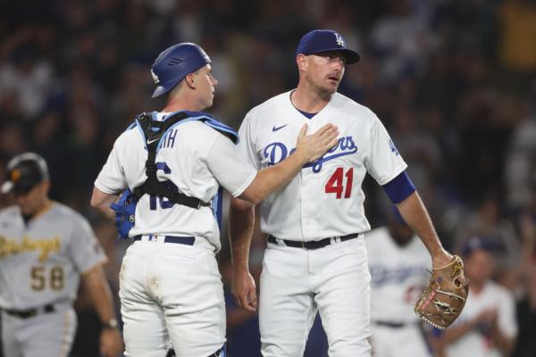 Daniel Hudson (41) of the Los Angeles Dodgers celebrates with his teammate Will Smith (16) after closing out the ninth inning with bases loaded to defeat the Pittsburgh Pirates at Dodger Stadium in Los Angeles on July 5, 2023. (Michael Owens/Getty Images)