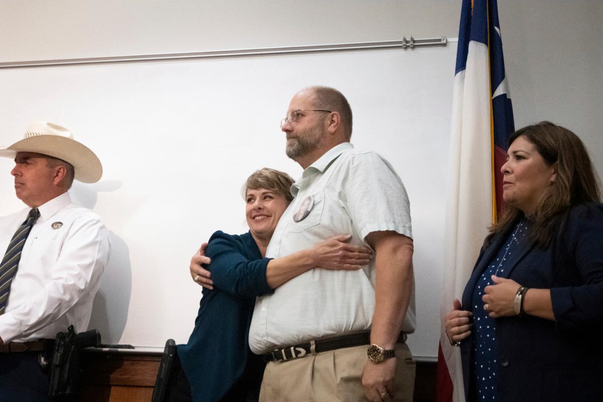 A San Marcos official embraces Brian Frizzell, father of fire victim Haley Frizzell, after his remarks during a press conference at San Marcos Fire Station Five in San Marcos, Texas, on July 6, 2023, about an arrest made in a 2018 deadly fire. (Sara Diggins/Austin American-Statesman via AP)
