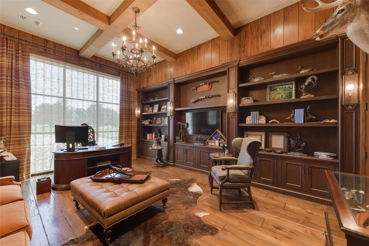 The private office in the main residence has built-in bookshelves, an exposed beam ceiling, and large windows to enjoy the view of the surrounding countryside. (Courtesy of Ragnar Fotografi / Sotheby’s Int’l Realty)