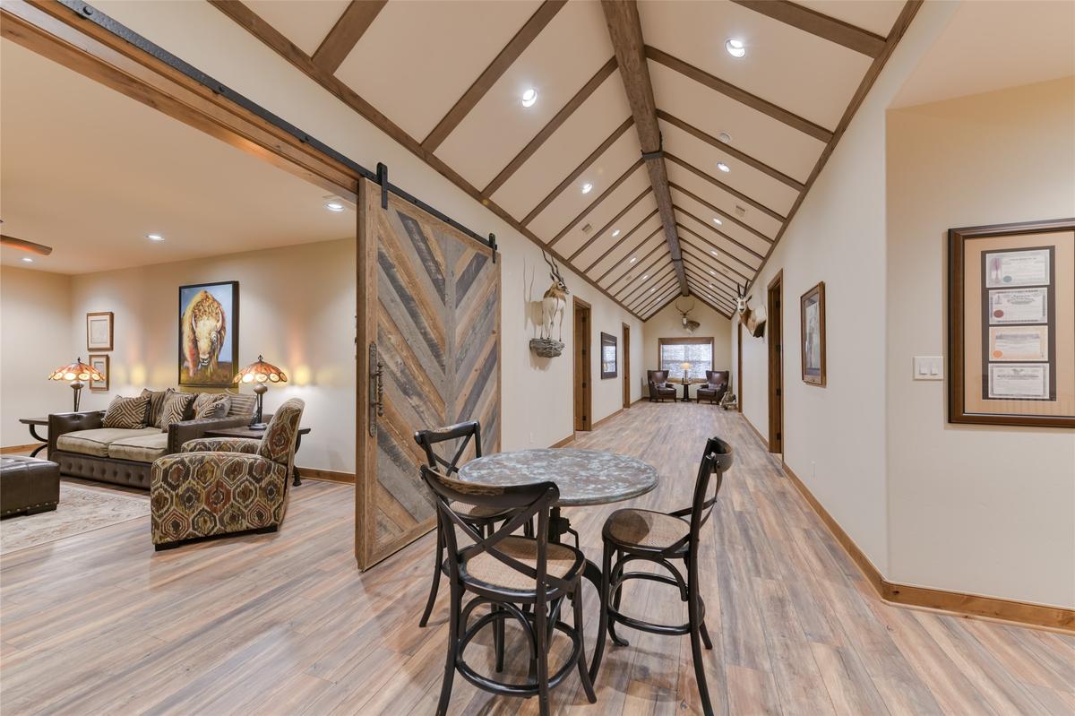 The property’s barn-like 10-car garage features six bedrooms for guests or staff, with a kitchen, living room, and dining area. (Courtesy of Ragnar Fotografi / Sotheby’s Int’l Realty)