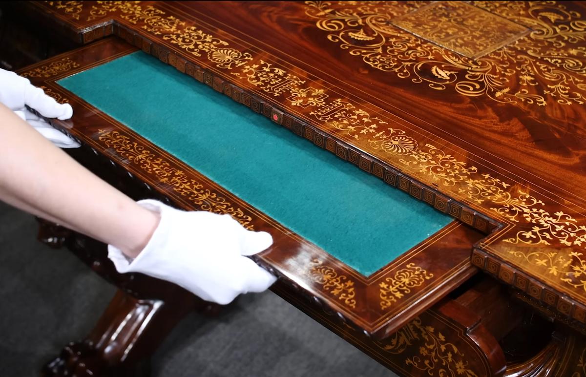 A writing slope comes out with the press of a button. (Courtesy of <a href="https://rauantiques.com/">M.S. Rau, News Orleans</a>)