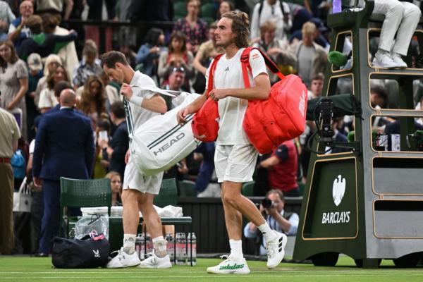 Britain's Andy Murray (L) and Greece's Stefanos Tsitsipas leave the court after their men's singles tennis match on the fourth day of the 2023 Wimbledon Championships at The All England Tennis Club in Wimbledon, southwest London, on July 6, 2023. (Glyn Kirk/AFP via Getty Images)