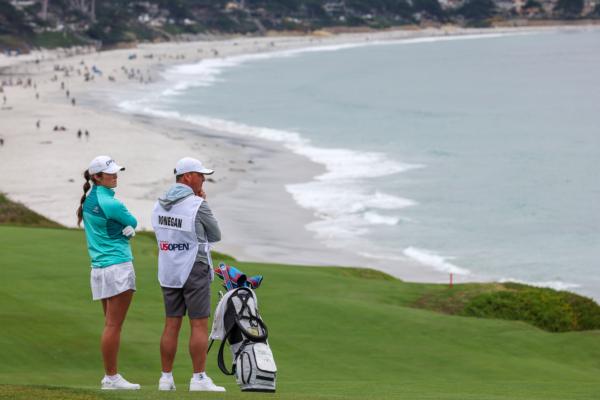 Amateur Áine Donegan of the Republic (T2) of Ireland waits with her caddie Gary Madden before playing a shot on the ninth hole during the first round of the 78th U.S. Women's Open at Pebble Beach Golf Links in Pebble Beach, Calif., on July 6, 2023. (Harry How/Getty Images)