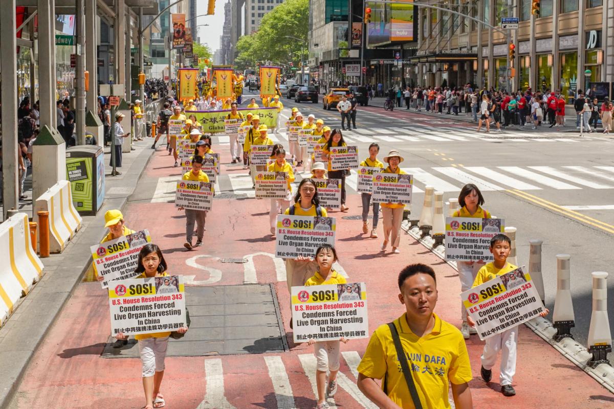 Falun Gong practitioners march in Manhattan to celebrate World Falun Dafa Day on May 12, 2023. (Larry Dye/The Epoch Times)