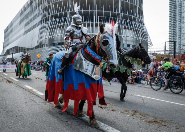 A knight in shining armour rides a steed during the Calgary Stampede parade in Calgary on July 7, 2023. (Jeff McIntosh/The Canadian Press)