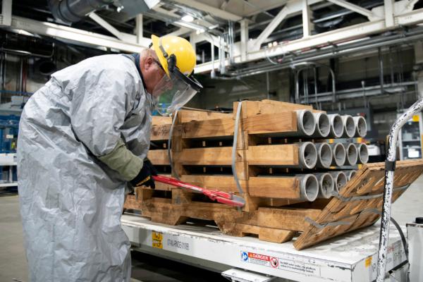 An operator cuts the metal bands on a pallet of M55 rockets containing GB nerve agent at the Blue Grass Army Depot near Richmond, Ky., on July 6, 2022. (U.S. Army via AP)