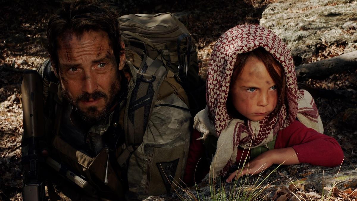 Master Chief Richard Mirko (Johnny Strong) and Zoe (Athena Durner) trying to escape Afghanistan, in "Warhorse One." (Well Go USA/Premiere Entertainment)
