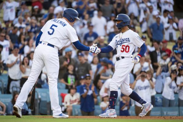 Los Angeles Dodgers' Mookie Betts (50), right, celebrates after his solo home run with Freddie Freeman (5) during the first inning of a baseball game against the Los Angeles Angels in Los Angeles on July 8, 2023. (Kyusung Gong/AP Photo)