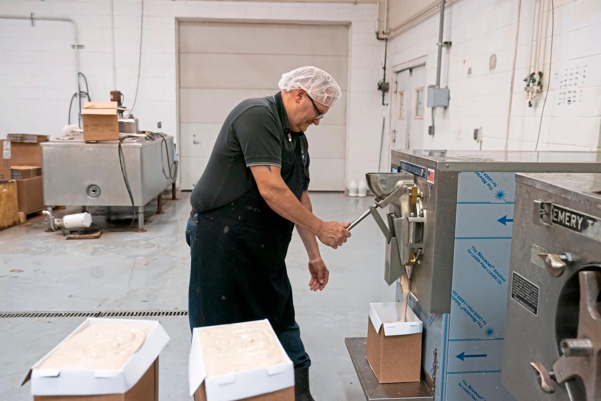 Tom Kerber Jr. Fills up cartons with coffee ice cream at his families dairy and ice cream store Kerber's Diary on Tuesday, June 13, 2023, in Irwin, Pennsylvania. (Benjamin B. Braun/Pittsburgh Post-Gazette/TNS)