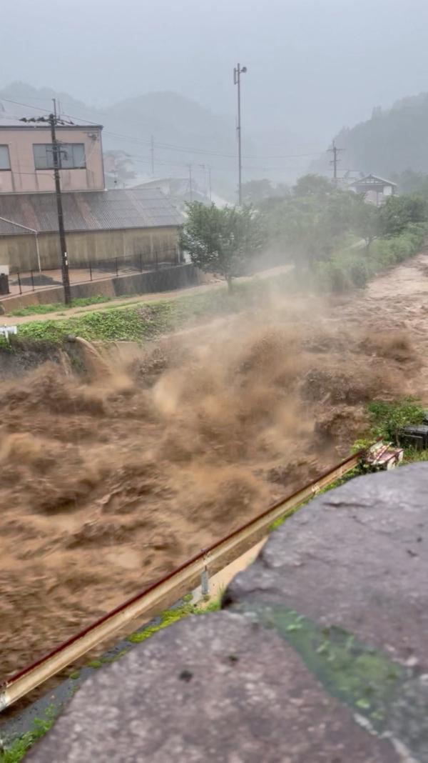 Rainwater rushes through a stream in Koishihara, Fukuoka prefecture, Japan on July 10, 2023 in this screengrab obtained from a social media video. (Twitter @zXshun/via Reuters)