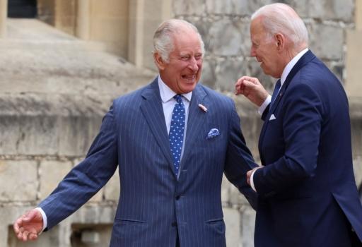 US President Joe Biden and Britain's King Charles III react as they walk after a ceremonial welcome in the Quadrangle at Windsor Castle in Windsor on July 10, 2023. (Ian Vogler/AFP via Getty Images)
