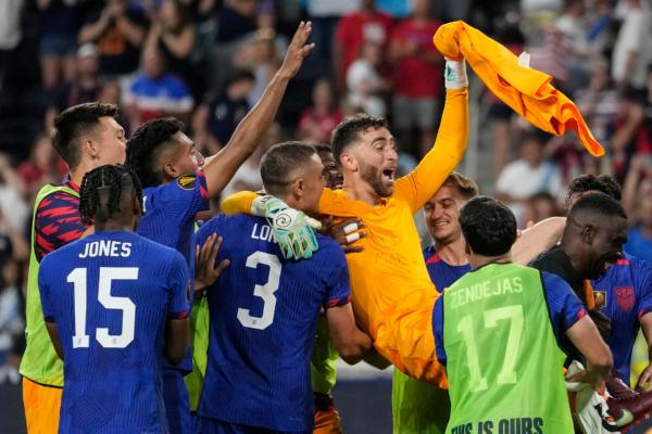 Team USA hoists their goalkeeper Matt Turner (1) in extra time in a penalty shootout during a CONCACAF Gold Cup semi-final soccer match against Canada in Cincinnati on July 9, 2023. (Michael Conroy/AP Photo)