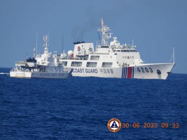 A Chinese Coast Guard ship allegedly obstructs the Philippine Coast Guard vessel Malabrigo as it provided support during a Philippine Navy operation near Second Thomas Shoal in the disputed South China Sea, June 30, 2023, in this handout image released July 5, 2023. (Philippine Coast Guard/Handout via Reuters)