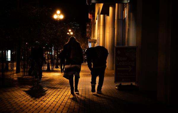 A mother walks with her son who is homeless and addicted to fentanyl in San Francisco, Calif., on Feb. 22, 2023. (John Fredricks/The Epoch Times)