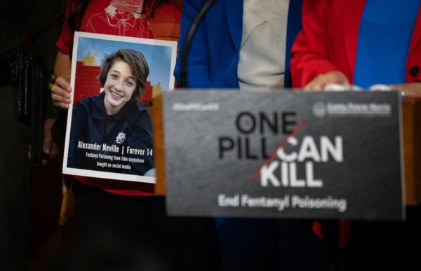 A photo of 14-year-old Alexander Neville who died after accidentally taking fentanyl is held in Irvine, Calif., on April 28, 2023. (John Fredricks/The Epoch Times)