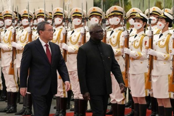 Solomon Islands Prime Minister Manasseh Sogavare (R) and China's Premier Li Qiang inspect the guard of honor during a welcome ceremony at the Great Hall of the People in Beijing on July 10, 2023. (Andy Wong/P00l/AFP via Getty Images)