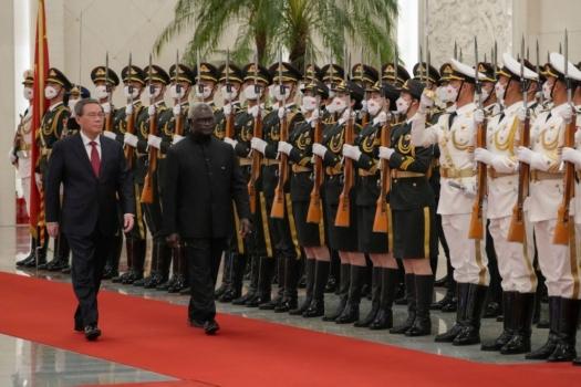 Solomon Islands' Prime Minister Manasseh Sogavare (R) and China's Premier Li Qiang inspect the guard of honour during a welcome ceremony at the Great Hall of the People in Beijing, China on July 10, 2023. (Andy Wong/POOL/AFP via Getty Images)