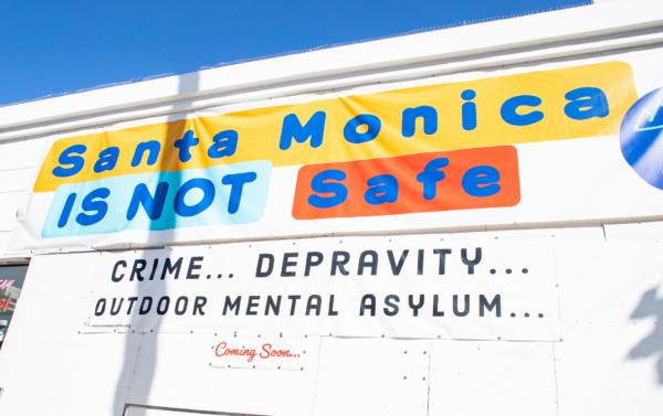 A banner covers part of the display in front of a popular shopping area of Santa Monica, Calif., on Jan. 19, 2023. (John Fredricks/The Epoch Times)