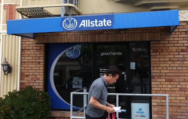 A pedestrian walks by an Allstate Insurance office in San Francisco on June 9, 2023. Allstate Insurance is following the lead of State Farm Insurance and discontinuing homeowners insurance for California residents. (Justin Sullivan/Getty Images)