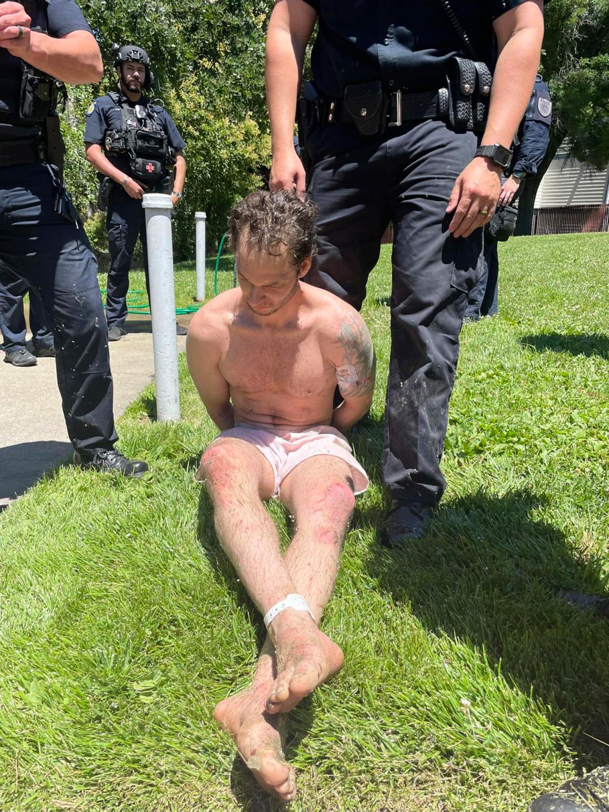 In this photo provided by the Placer County Sheriff's Office, fugitive Eric Abril sits after being taken into custody by police in Rocklin, Calif., on July 10, 2023. (Placer County Sheriff's Office via AP)