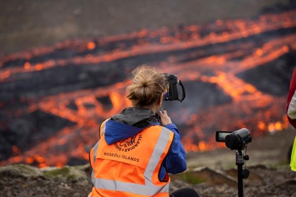 Scientists and students of the department of Geology of the University of Iceland observe the eruption and take measurements of the Fagradalsfjall volcano near the Litli-Hrútur mountain, some 30 kilometers southwest of Reykjavik, Iceland, on July 10, 2023. (Marco Di Marco/AP Photo)