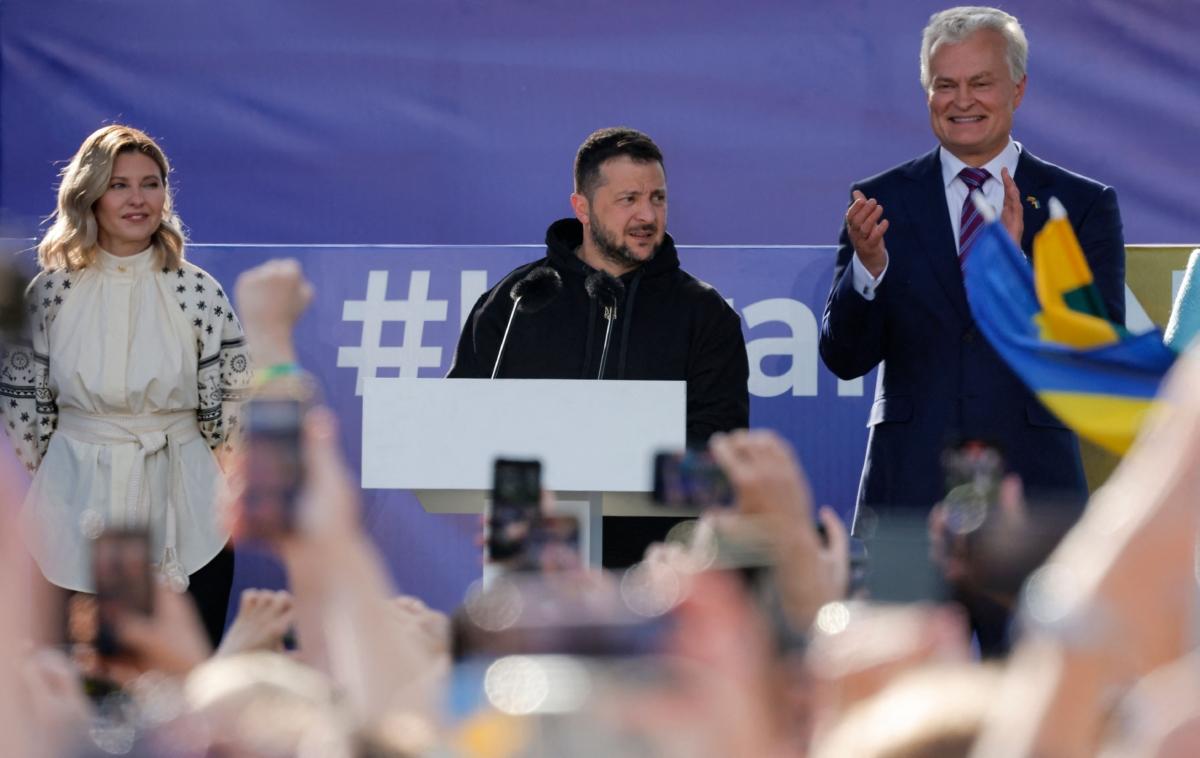 Ukrainian President Volodymyr Zelenskyy (C) addresses the crowd while flanked by his wife Olena Zelenska (L) and Lithuanian President Gitanas Nauseda at Lukiskiu Square in Vilnius, Lithuania, during the NATO Summit on July 11, 2023. (Odd Andersen/AFP via Getty Images)