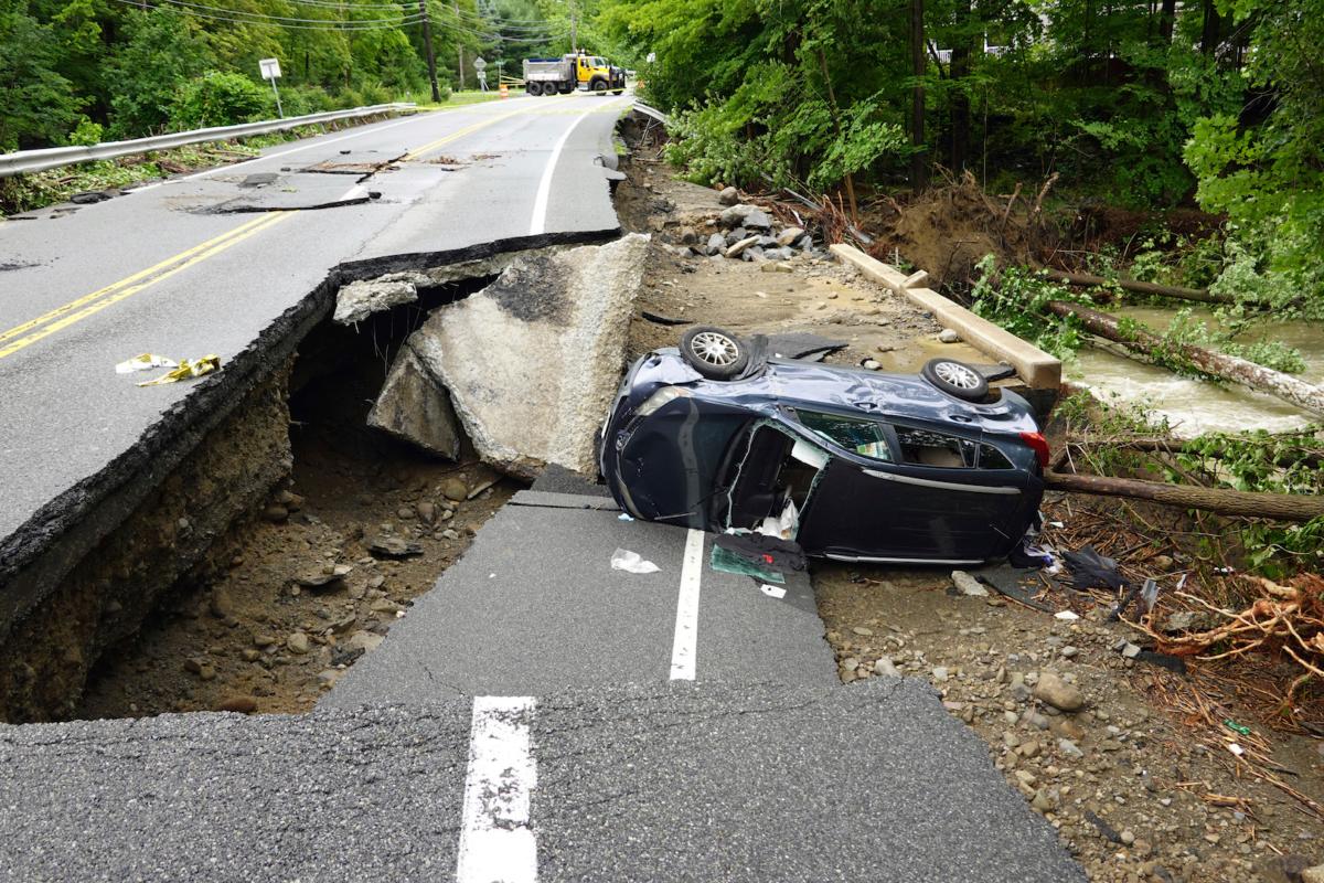 A damaged car lays on a collapsed roadway along Route 32 in the Hudson Valley near Cornwall, N.Y., on July 10, 2023. (Paul Kazdan/AP Photo)