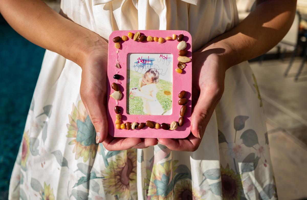 Chloe Cole holds a childhood photo in Northern California on Aug. 26, 2022. (John Fredricks/The Epoch Times)