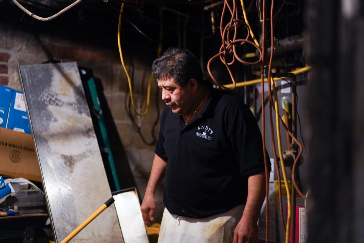 Andy's Restaurant owner Eddie Saavedra surveyed damages in the basement after a historic flood in Highland Falls, N.Y., on July 10, 2023. (Cara Ding/The Epoch Times)