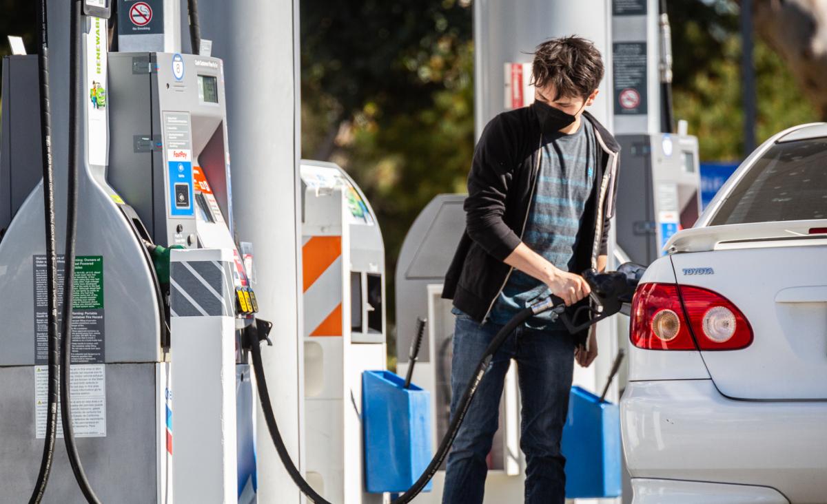 A customer pumps gas in Irvine, Calif., on Feb. 23, 2022. (John Fredricks/The Epoch Times)