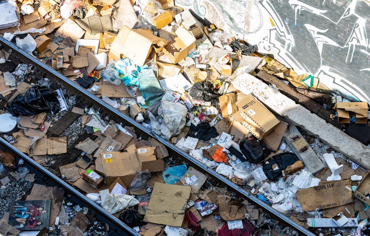 Cardboard boxes lay strewn across railroad tracks three miles from downtown Los Angeles on Jan. 14, 2022. (John Fredricks/The Epoch Times)