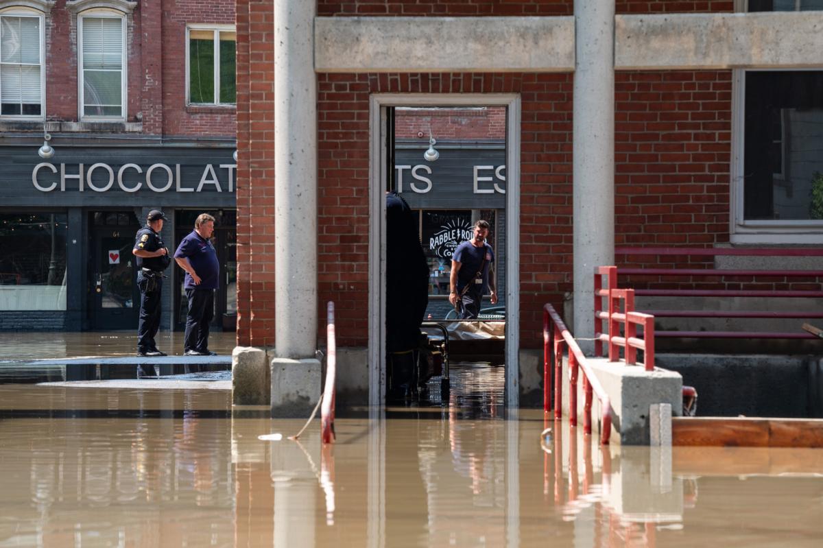 Firefighters and police officers assess the flood waters inside and around the Montpelier Fire and Ambulance Department in Montpelier, Vt., on July 11, 2023. (Kylie Cooper/Getty Images)