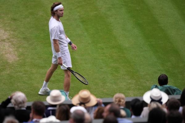 Russia's Andrey Rublev looks around at the crowd as he plays Serbia's Novak Djokovic in a men's singles match on day nine of the Wimbledon tennis championships in London on July 11, 2023. (Alberto Pezzali/AP Photo)