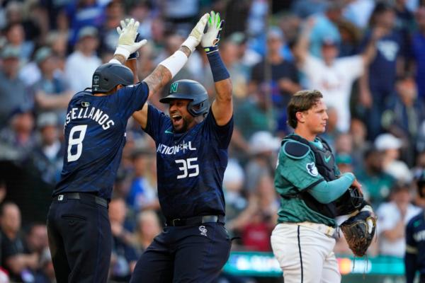 National League's Elias Díaz, of the Colorado Rockies (35), celebrates his two run home run with Nick Castellanos (8), of the Philadelphia Phillies, in the eighth inning during the MLB All-Star baseball game in Seattle on July 11, 2023. (Lindsey Wasson/AP Photo)