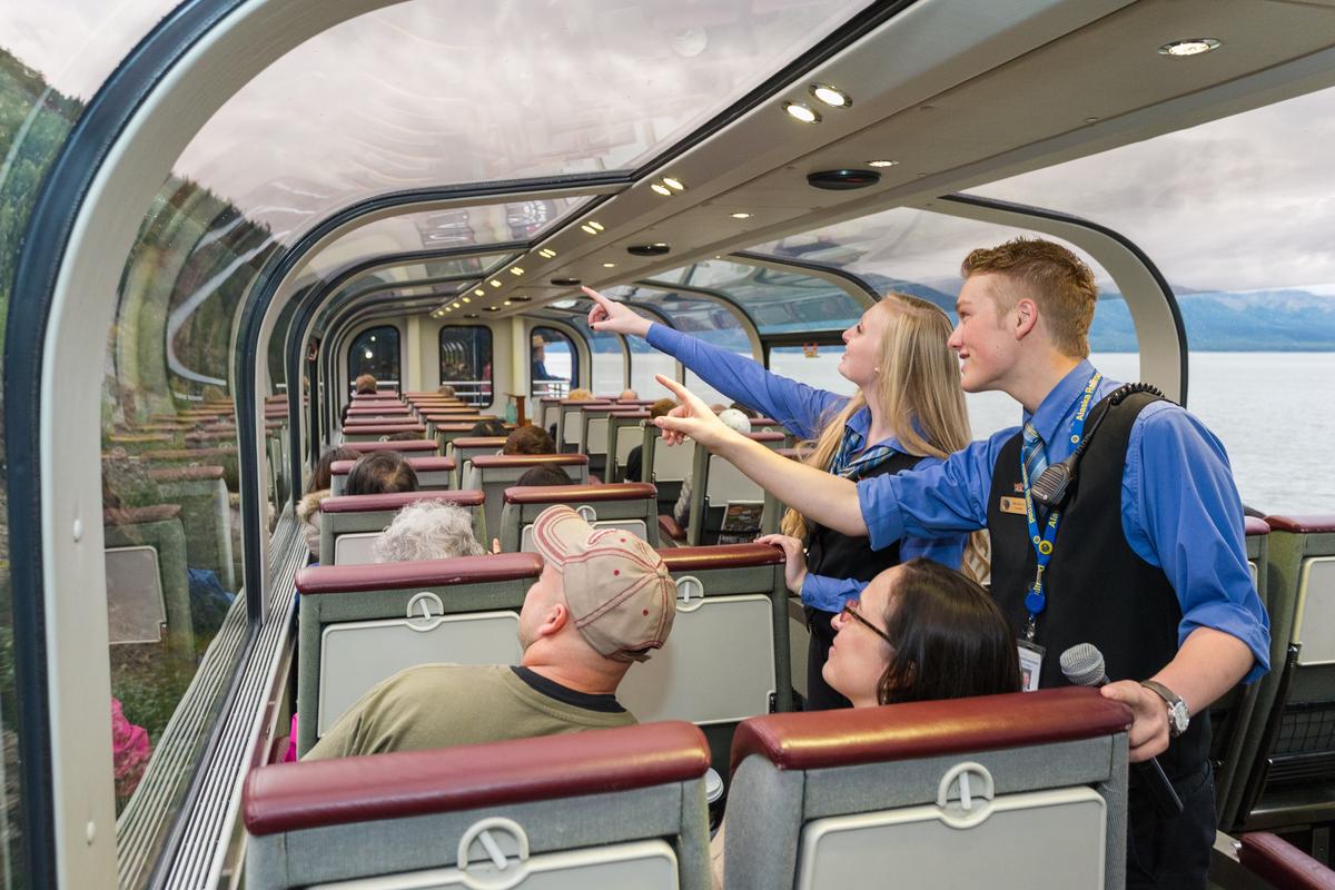 Tour guides point out the sights to passengers in the Alaskan Railroad GoldStar Dome service. (Courtesy of Alaska Railroad)