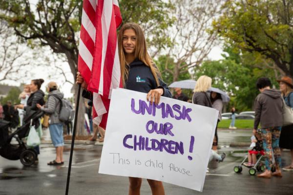 Mariners Christian private school student Presley Penkeatou stands with parents and students as they gather in protests of wearing masks in schools in front of The Orange County Board of Education in Costa Mesa, Calif., on May 17, 2021. (John Fredricks/The Epoch Times)
