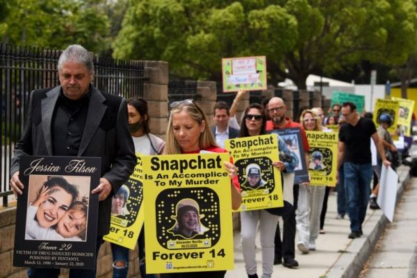 Steve Filson (L), whose daughter Jessica Filson died in January 2020 of fentanyl poisoning, and Amy Neville (R), whose son Alexander Neville died in June 2020 at the age of 14 of fentanyl poisoning, march with family and friends to protest outside of the Snap, Inc. headquarters, makers of the Snapchat social media application, in Santa Monica, Calif., on June 4, 2021. (Patrick T. Fallon/AFP via Getty Images)