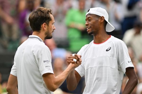 Russia's Daniil Medvedev (L) shakes hands after winning against US player Christopher Eubanks during their men's singles quarter-finals tennis match on the tenth day of the 2023 Wimbledon Championships at The All England Lawn Tennis Club in Wimbledon, London, on July 12, 2023. (Glyn Kirk/AFP via Getty Images)
