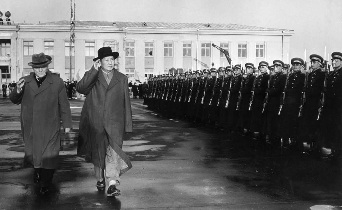 Chinese leader Mao Zedong (1893–1976) (R) and Soviet Chief of Staff Marshall Kliment Yefremovich Voroshilov (1881–1969) salute while reviewing an Honor Guard upon Mao's arrival at the Moscow airport, Moscow, USSR (Russia). (Hulton Archive/Getty Images)