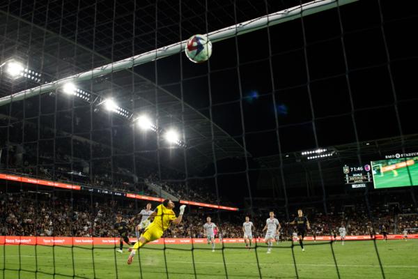 LAFC forward Carlos Vela (10) scores past St. Louis City SC goalkeeper Roman Burki at BMO Stadium in Los Angeles on July 12, 2023. (Courtesy of LAFC via The Epoch Times)