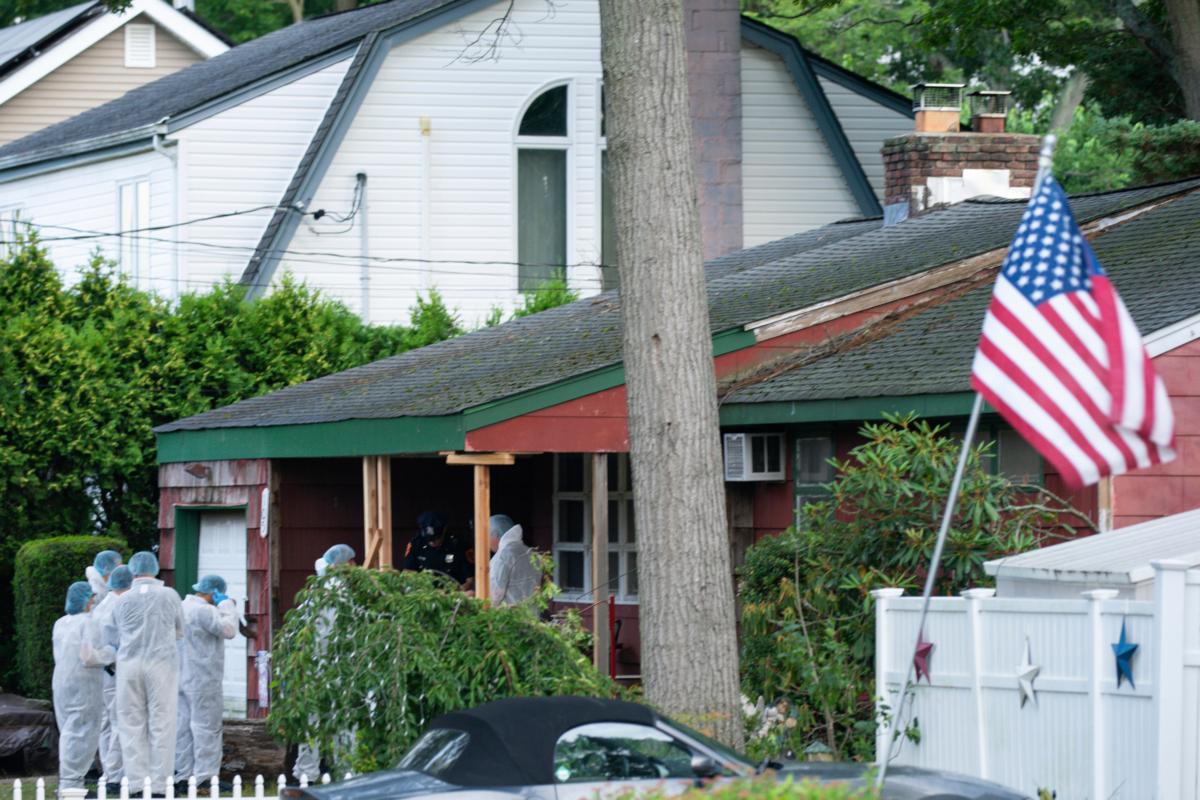 Crime laboratory officers arrive at the house where a suspect has been taken into custody on New York's Long Island in connection with a long-unsolved string of killings, known as the Gilgo Beach murders, in Massapequa Park, N.Y., on July 14, 2023 (Eduardo Munoz Alvarez/AP Photo)
