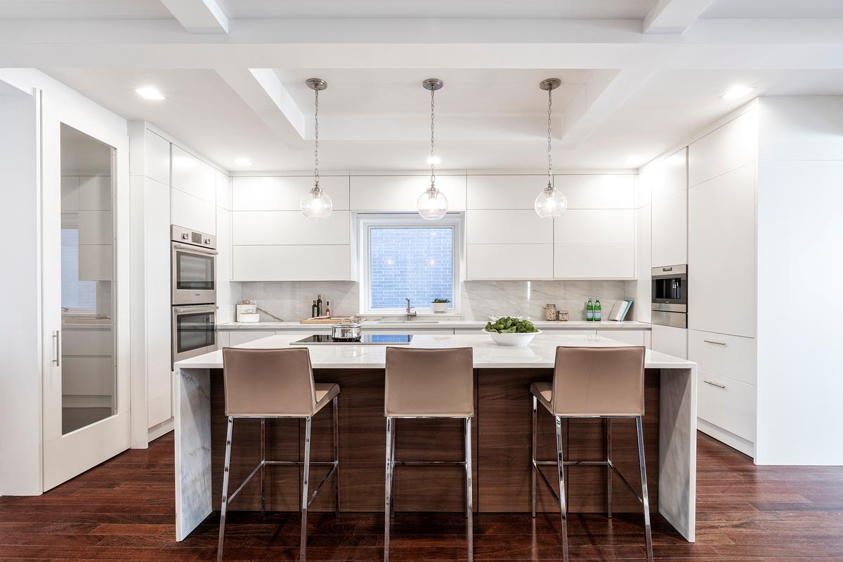 White cabinets paired with walnut wood help add an interesting sense of contrast. (Provided photo/TNS)