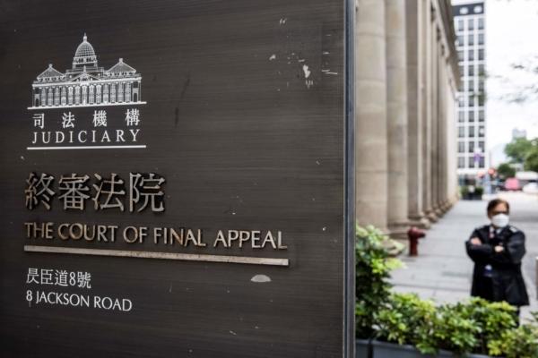 A security guard stands outside the Court of Final Appeal in Hong Kong on March 31, 2022. Australian and Canadian judges confirmed on March 31, 2022, that they will stay on Hong Kong's top court after two senior British judges resigned to avoid endorsing China's clampdown on political freedoms in the financial hub. (Isaac Lawrence/AFP via Getty Images)