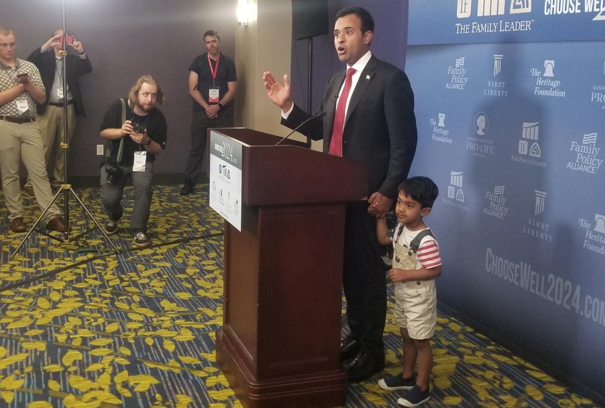 Presidential hopeful Vivek Ramaswamy stands with his son Karthik after speaking at a candidate forum in Des Moines on July 14, 2023. (Nathan Worcester/The Epoch Times)