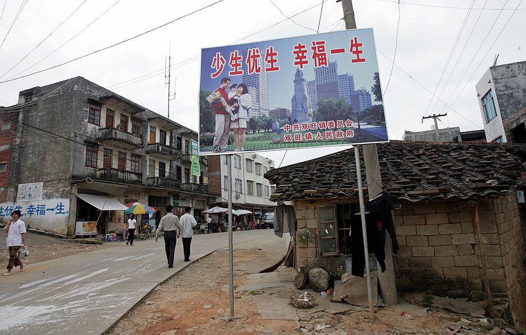 A Chinese "one-child" policy billboard saying, "Have fewer children, have a better life" greets residents on the main street of Shuangwang, in China's Guangxi region, on May 25, 2007. (Goh Chai Hin/AFP via Getty Images)
