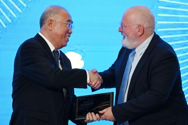 European Commission Executive Vice President Frans Timmermans (right) shakes hands with Xie Zhenhua, China's Special Envoy for Climate Change, after Mr. Timmermans delivered a speech about climate change to students at Tsinghua University in Beijing, China, on July 3, 2023. (Greg Baker/AFP via Getty Images)