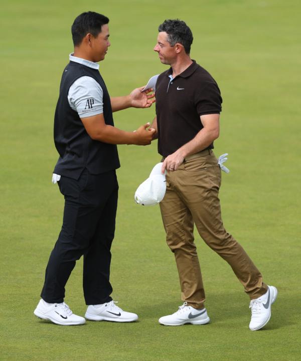 Tom Kim of South Korea and Rory McIlroy of Northern Ireland shake hands on the 18th green after finishing their round during Day Three of the Genesis Scottish Open at The Renaissance Club in Scotland on July 15, 2023. (Andrew Redington/Getty Images)