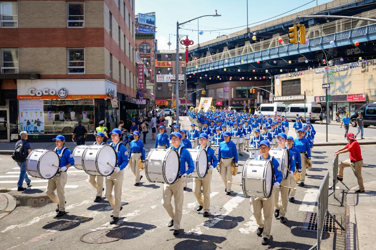 Falun Gong practitioners take part in a parade to commemorate the 24th anniversary of the persecution of the spiritual discipline in China, in New York's Chinatown on July 15, 2023. (Samira Bouaou/The Epoch Times)